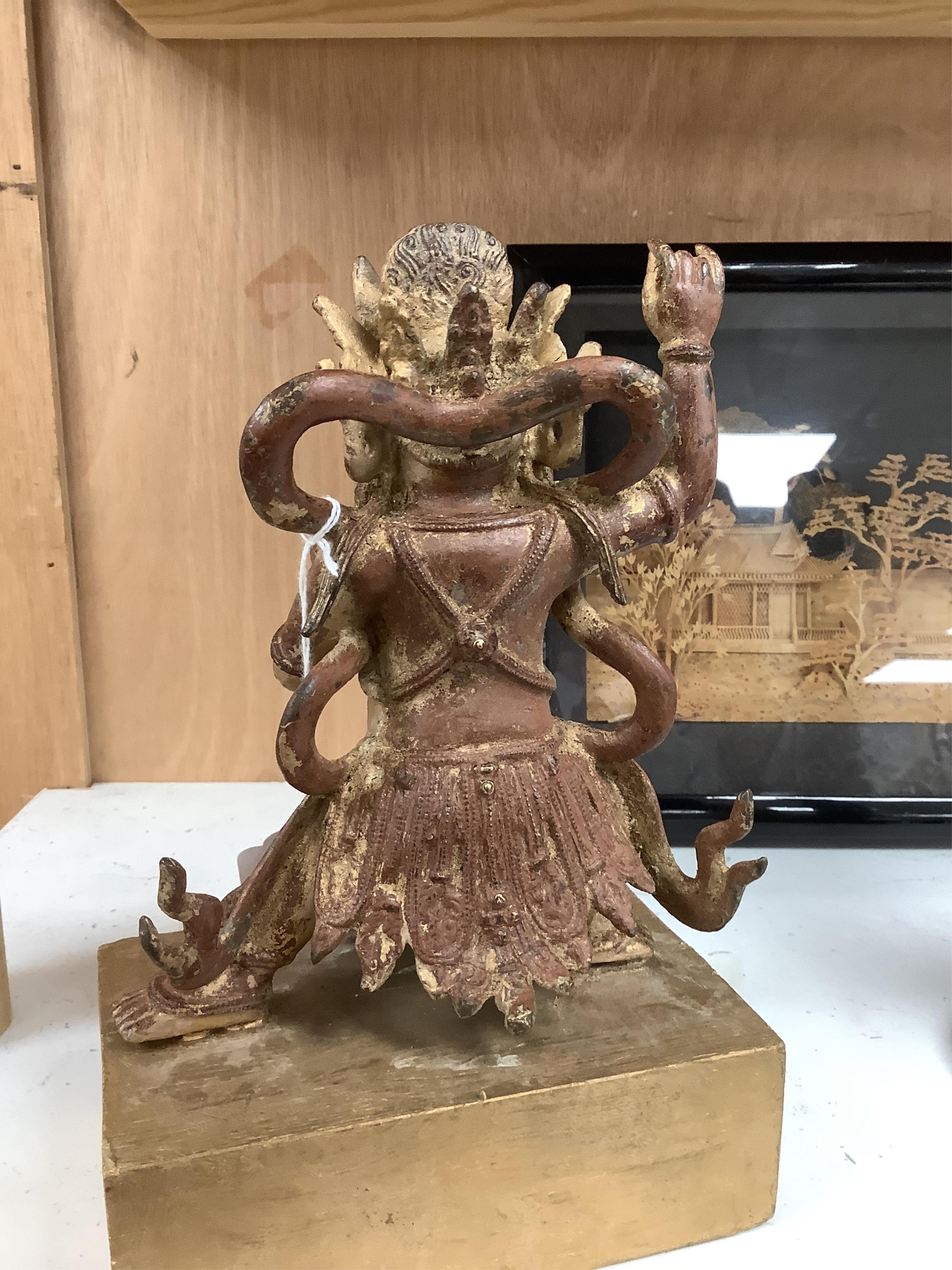 A Buddhist gilt bronze figure of Vaishravana, possibly Tibetan, 21 cm including wooden stand.
